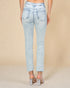 Light blue jeans worn by a person on a beige background