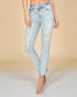 Light blue distressed jeans worn by a person on a beige background