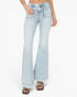 A model wearing light-wash blue flare jeans with rolled cuffs and black strappy sandals, shown from the waist down on a plain white studio background.