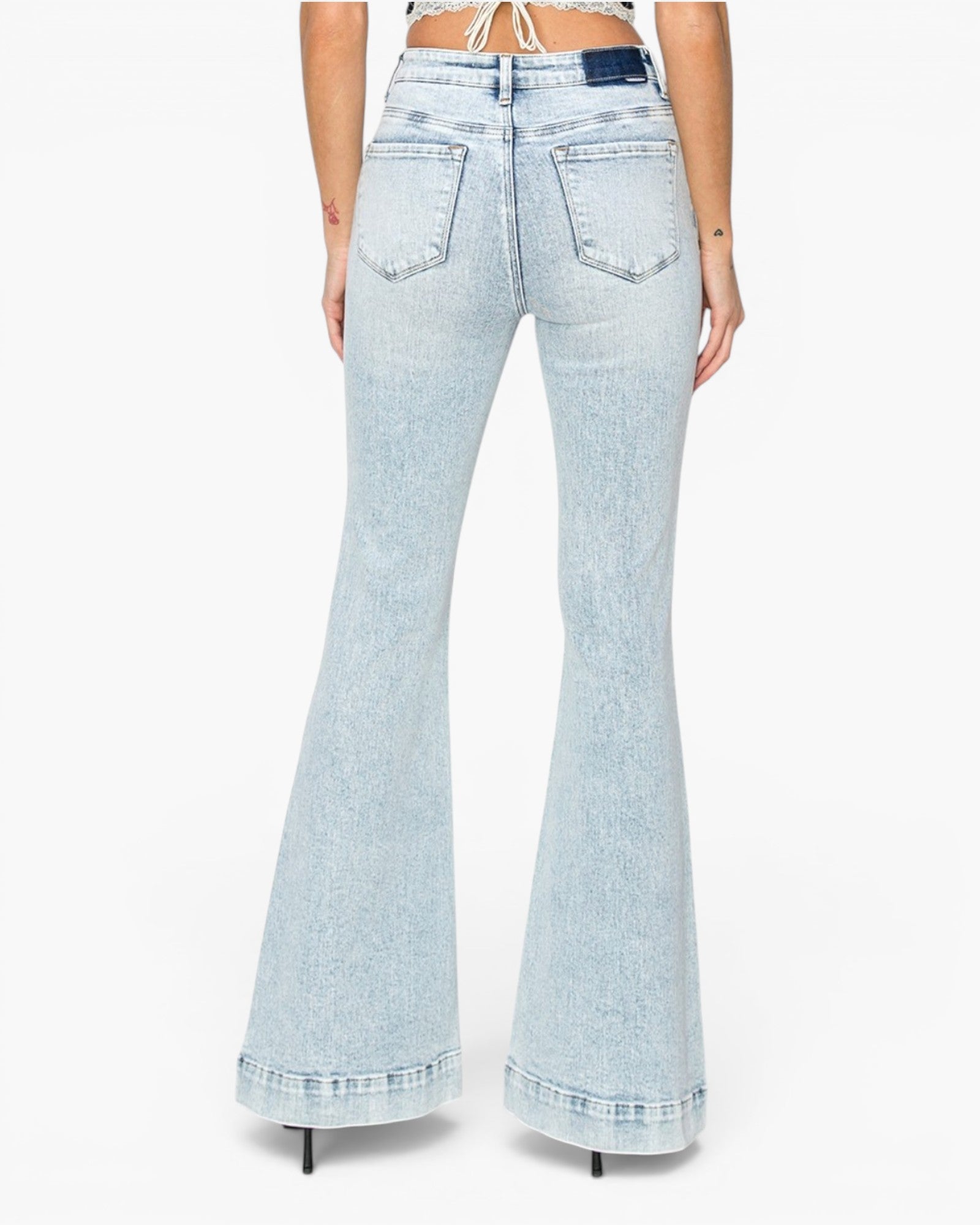 Light wash blue flare jeans shown from the back on a model, featuring a high waist, back pockets, and a flared leg.
