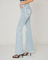 Light blue flared jeans worn by a person on a plain background