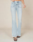 Light blue jeans worn by a person on a beige background