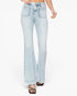 A person wearing light-wash blue flare jeans with a high waist, front patch pockets, and rolled hems, paired with black strappy heels against a plain white studio background.