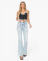 A woman modeling a black and white striped crop top with spaghetti straps and light-wash blue flare jeans, paired with black sandals, against a plain white studio background.