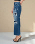 Blue distressed jeans worn by a person on a beige background