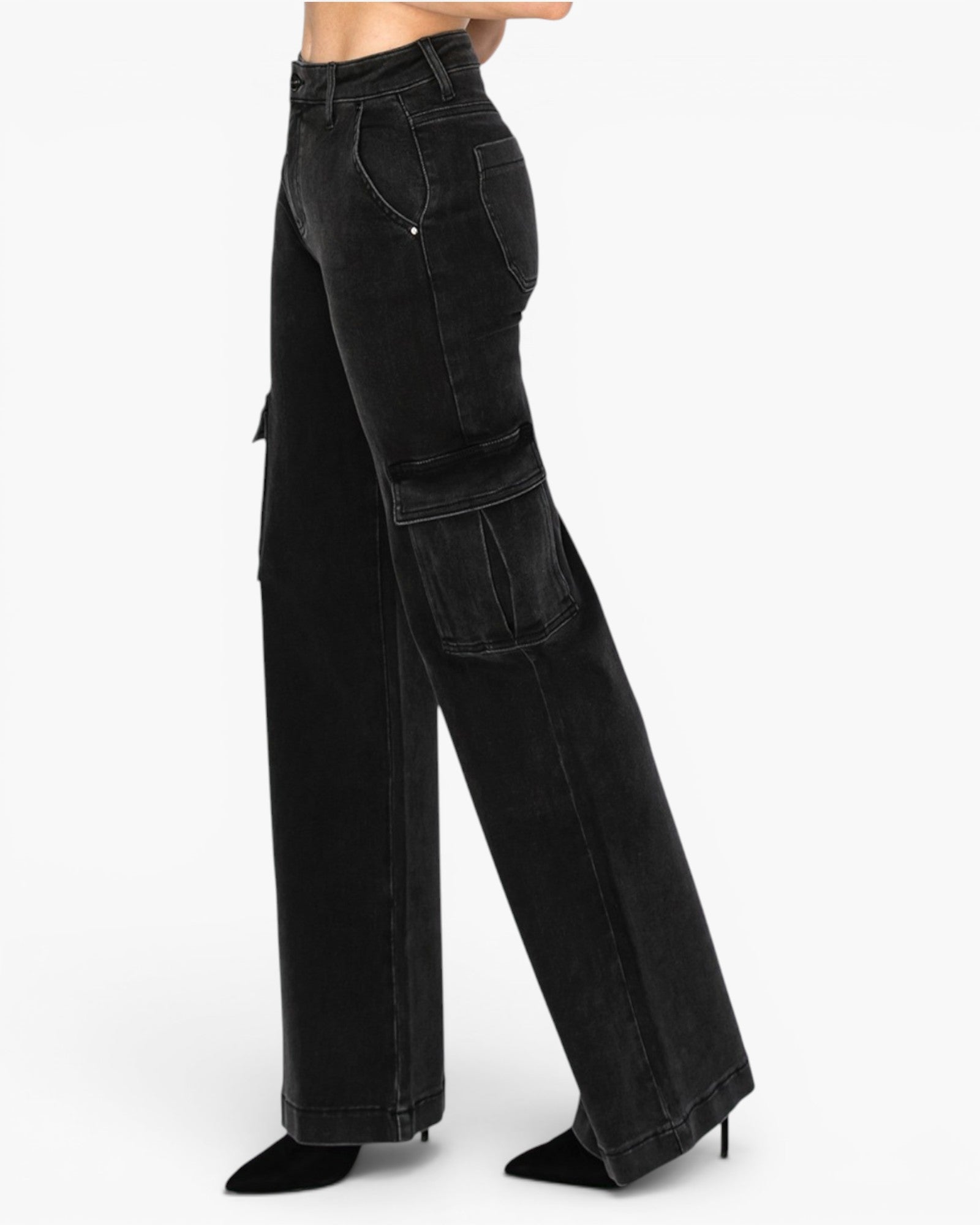 Black wide-leg cargo jeans with side pockets, modeled from the waist down on a white studio background.