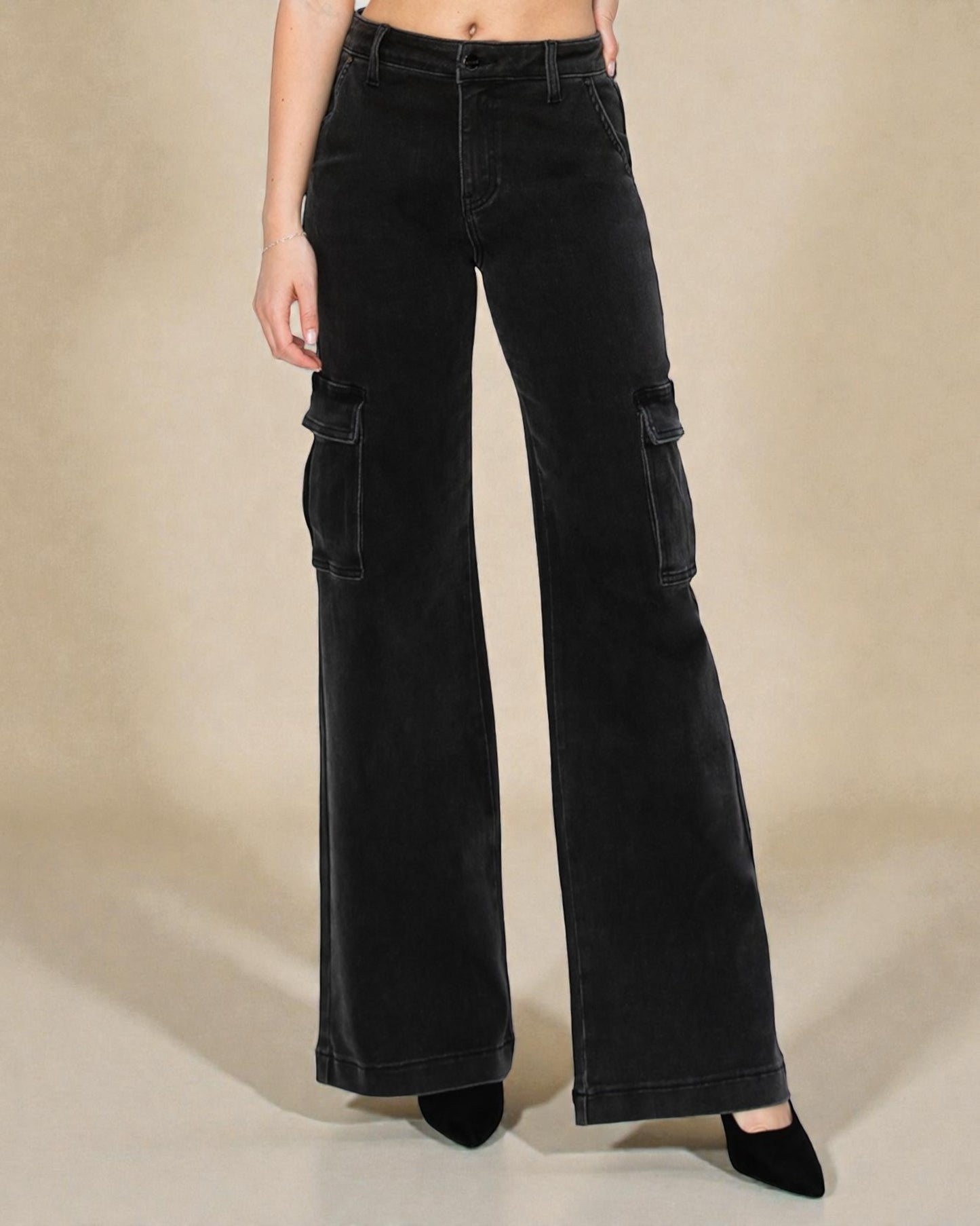 Black cargo pants worn by a person on a beige background