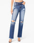 A model wearing a pair of high-waisted, distressed blue denim jeans with frayed knee hems and ripped details, paired with clear-strap heels against a plain white background.