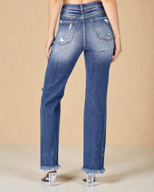 Blue jeans worn by a person on a beige background