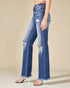 Blue distressed jeans worn by a person on a beige background