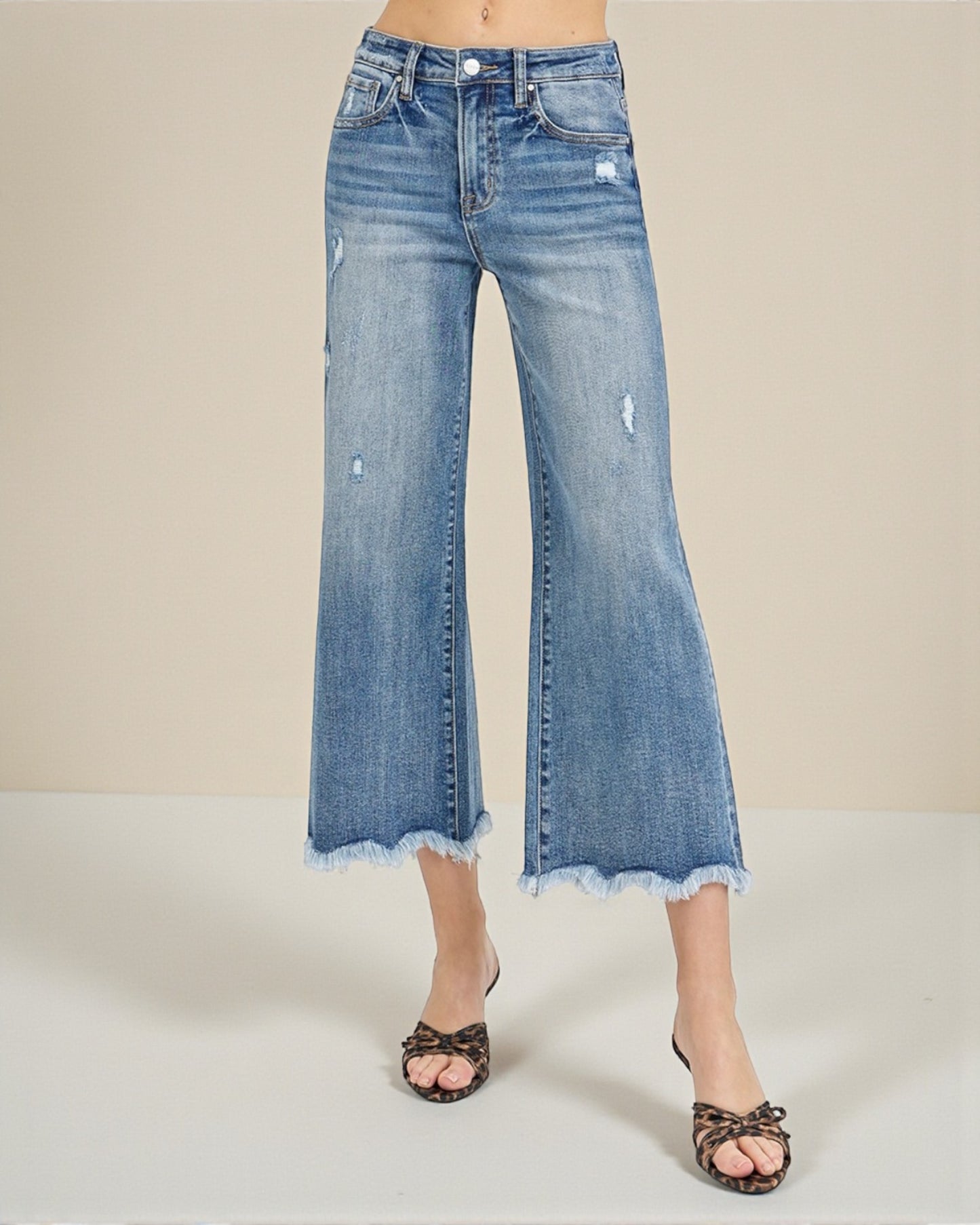Blue denim wide-leg jeans on a neutral background