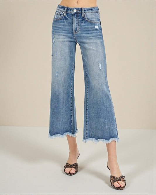 Blue denim wide-leg jeans on a neutral background