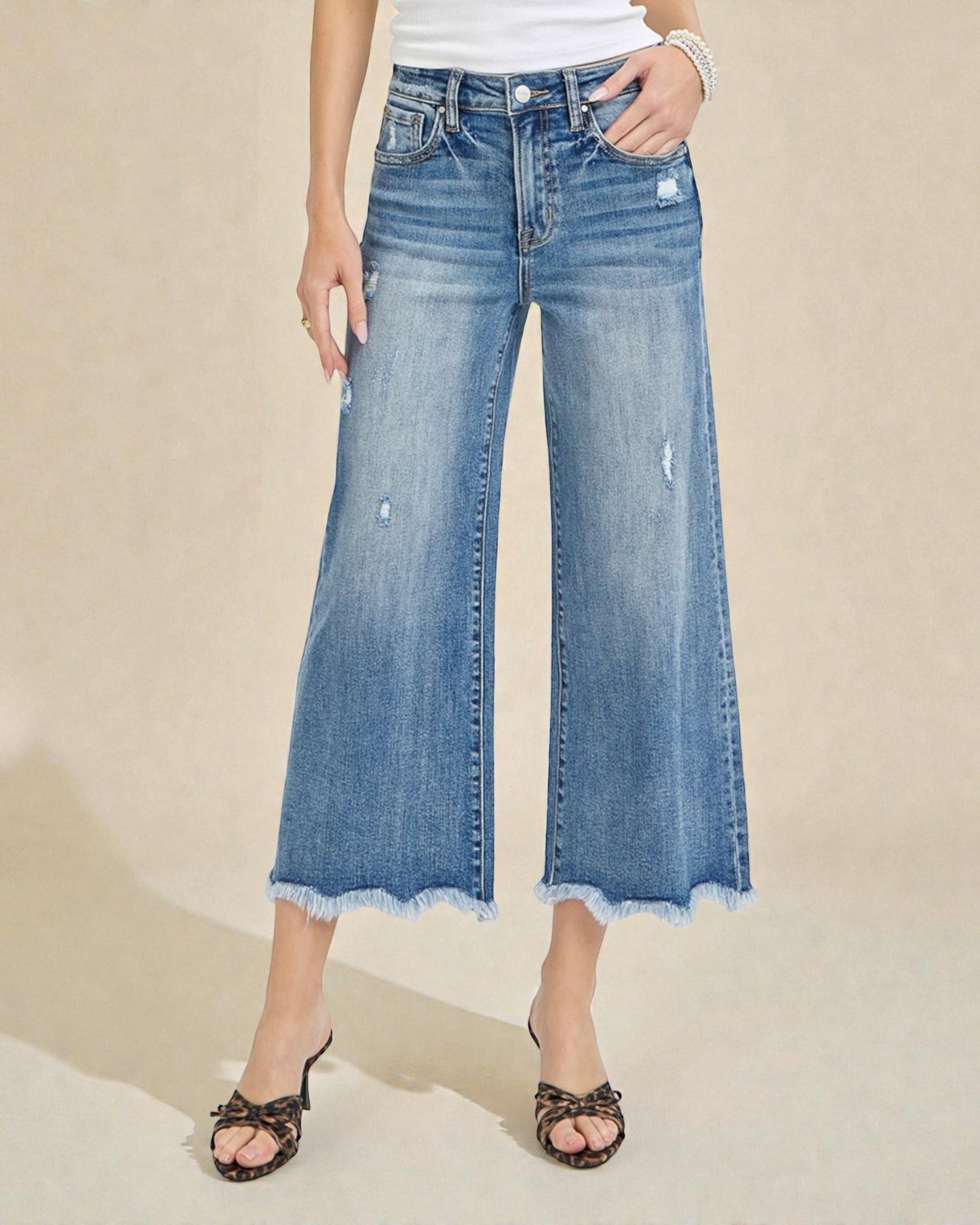 Wide-leg jeans worn by a person on a beige background