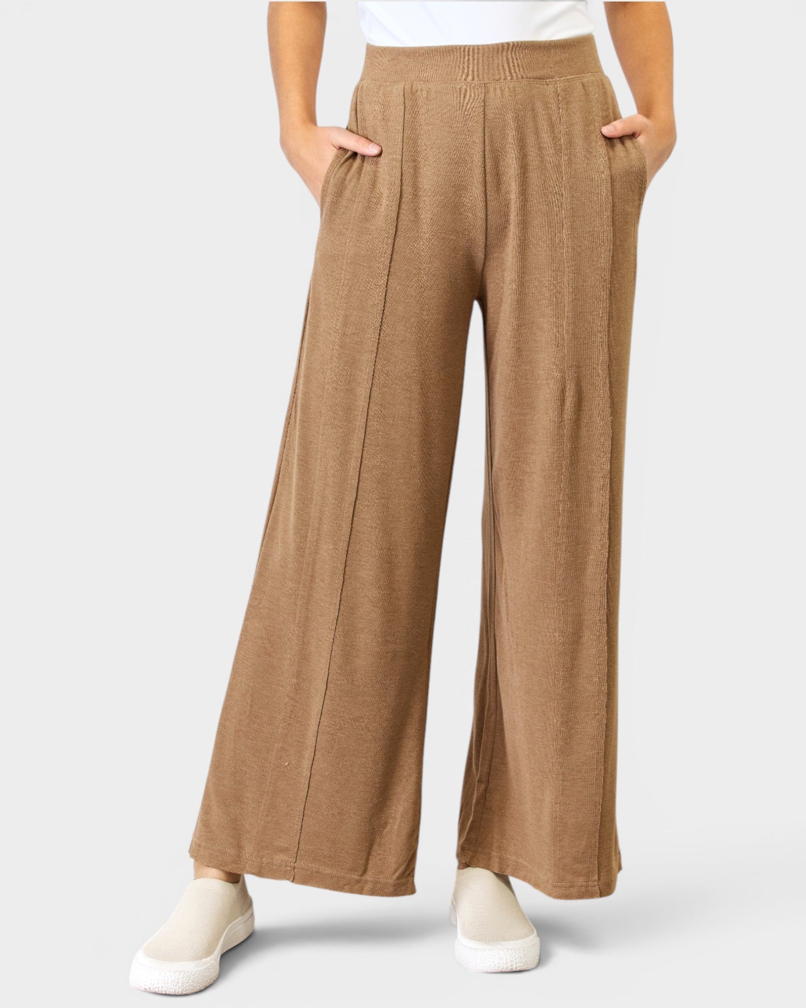 Tan wide-leg pants worn by a person on a white background