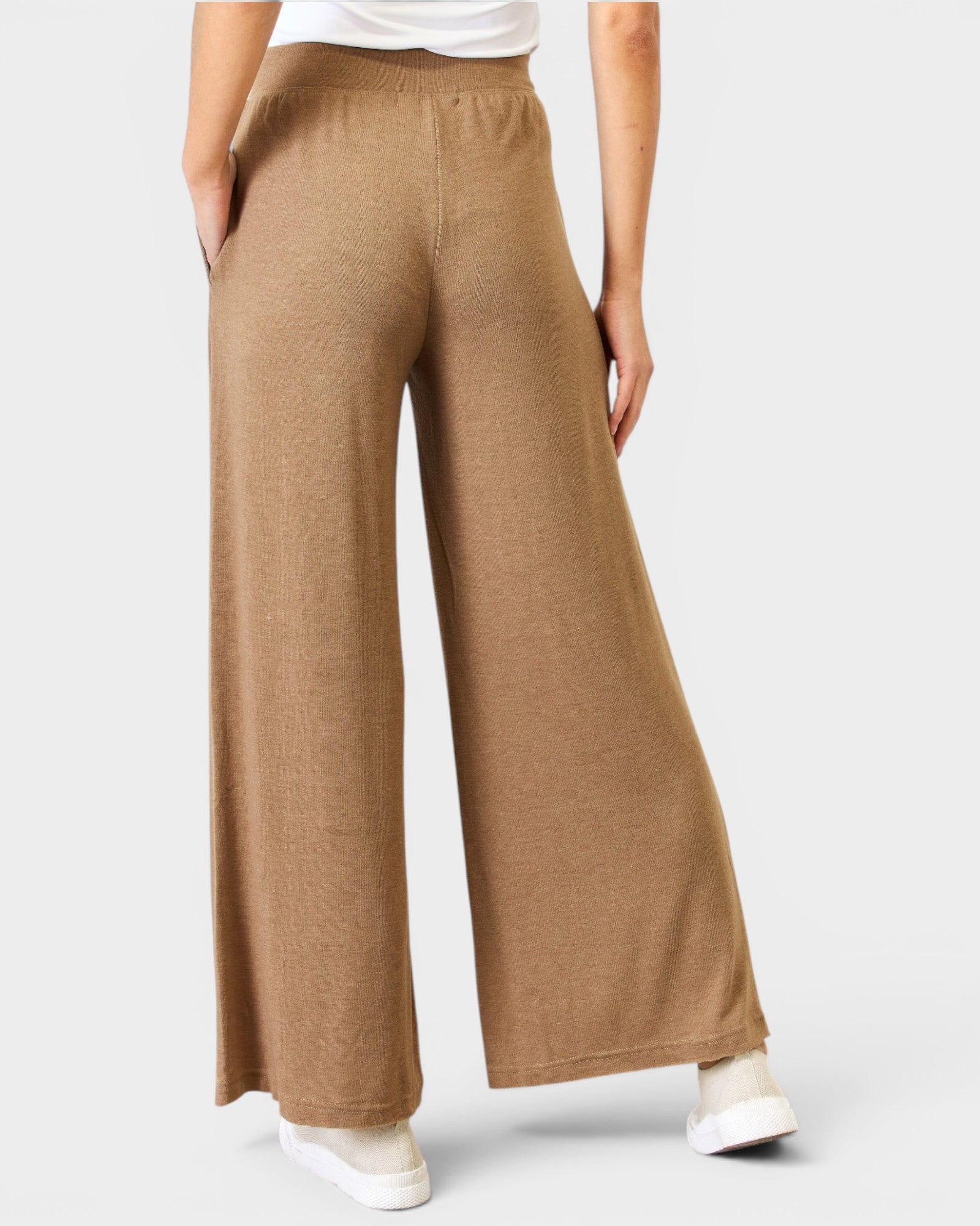 Brown wide-leg pants worn by a person on a light gray background