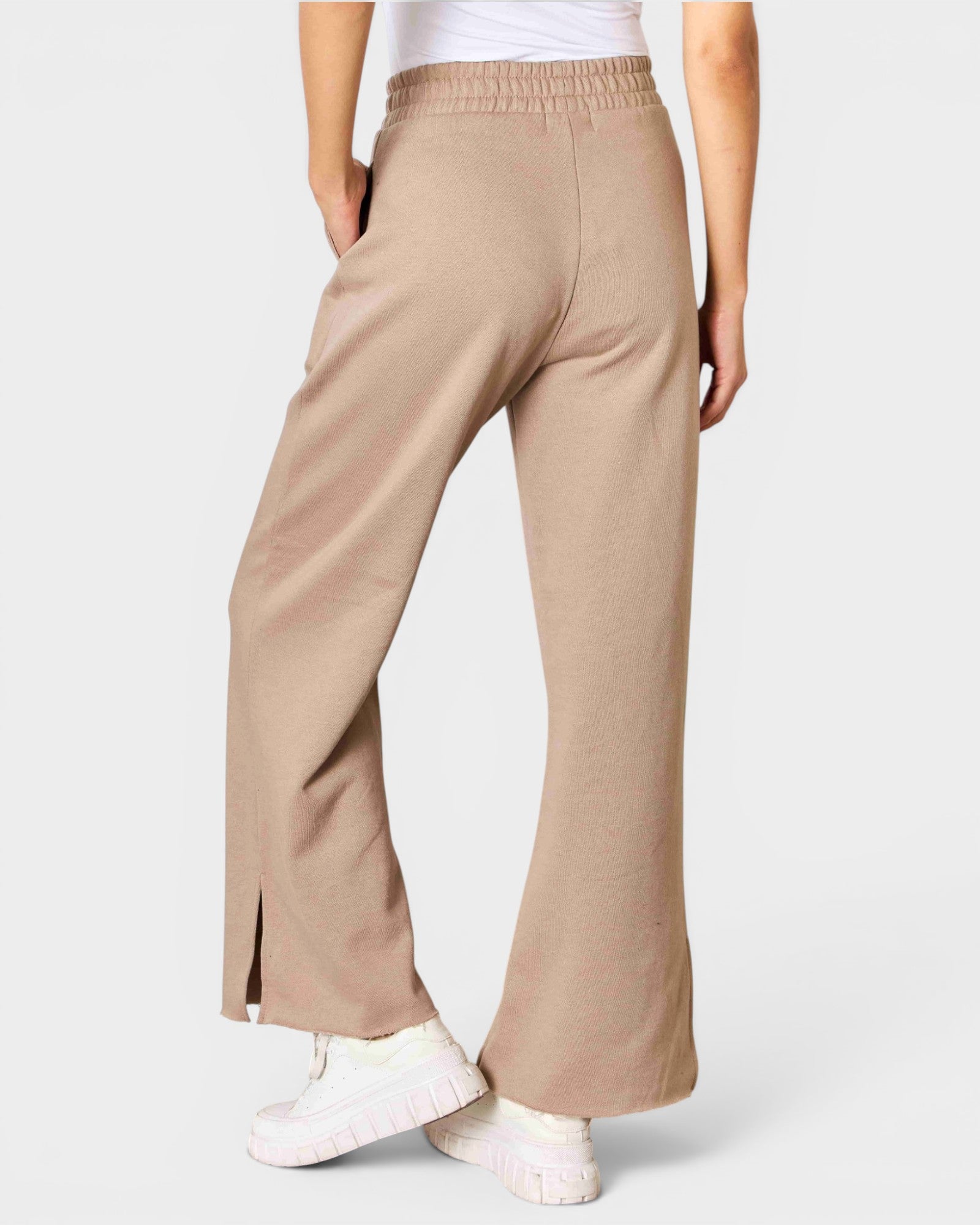 Beige pants worn by a person on a light gray background