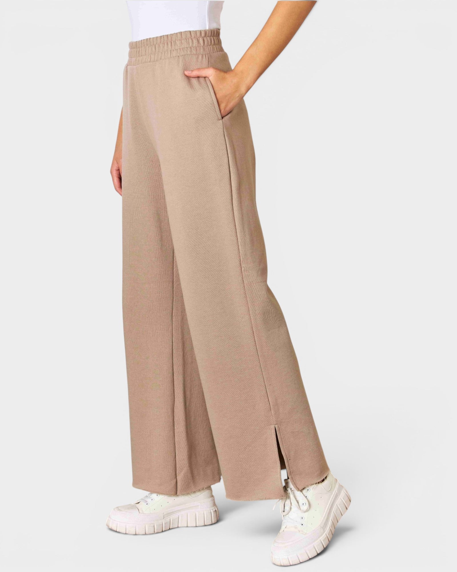 Beige wide-leg pants worn by a person on a white background