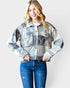 Woman wearing a plaid jacket and jeans on a white background