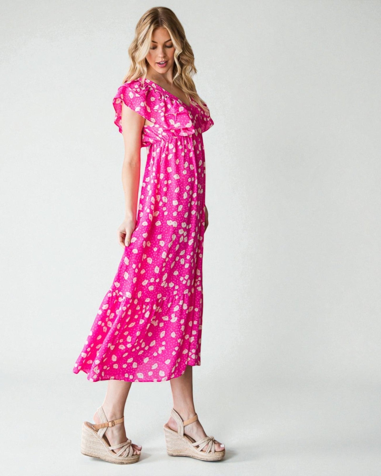 Woman wearing a pink floral dress on a white background