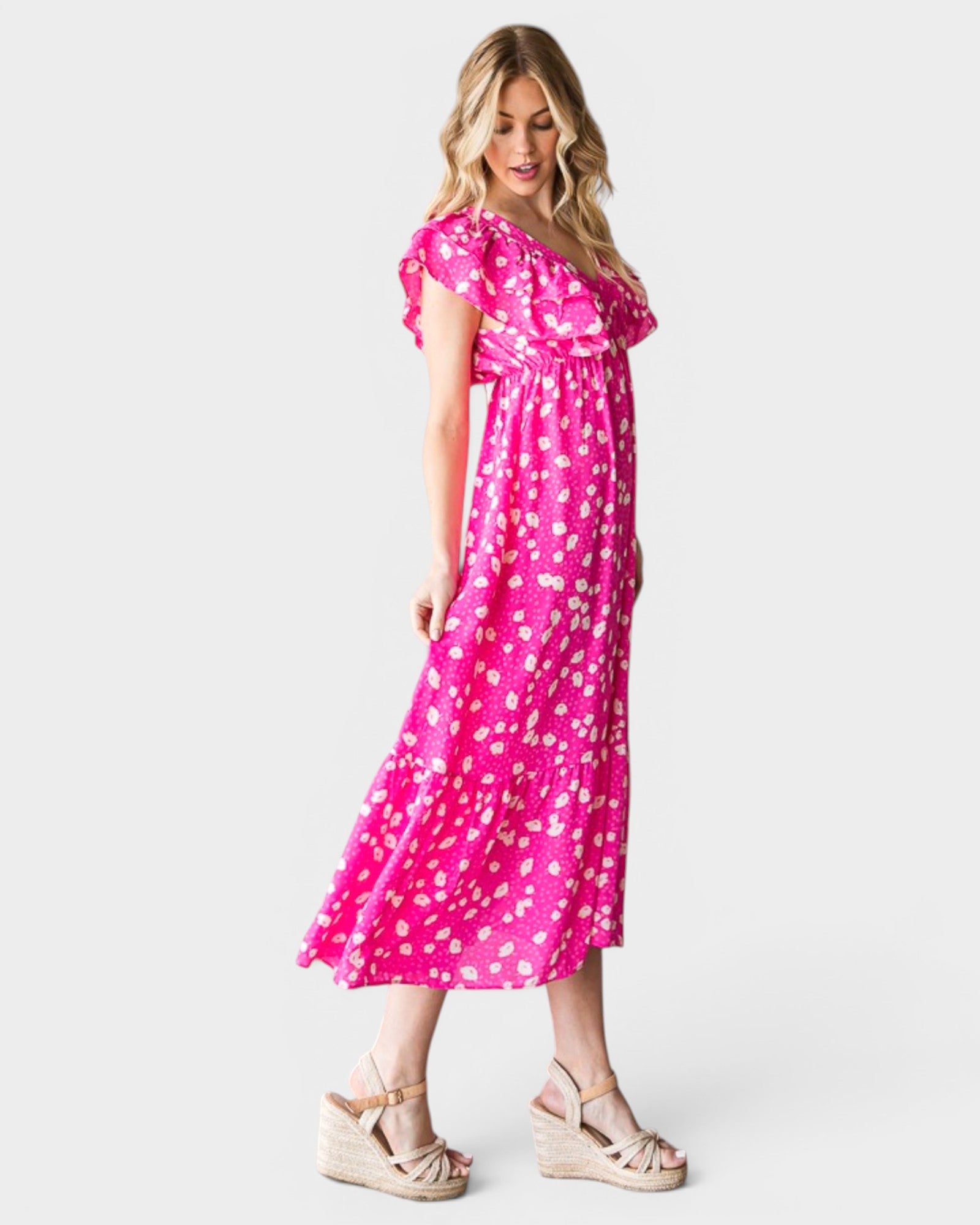 Woman wearing a pink floral dress on a white background