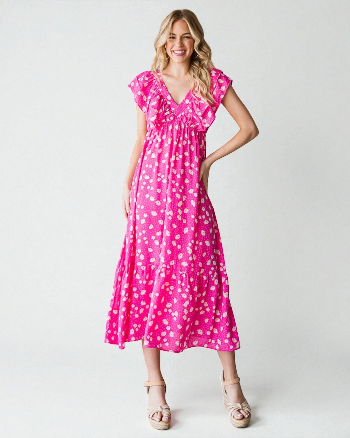 Woman wearing a pink floral dress on a white background