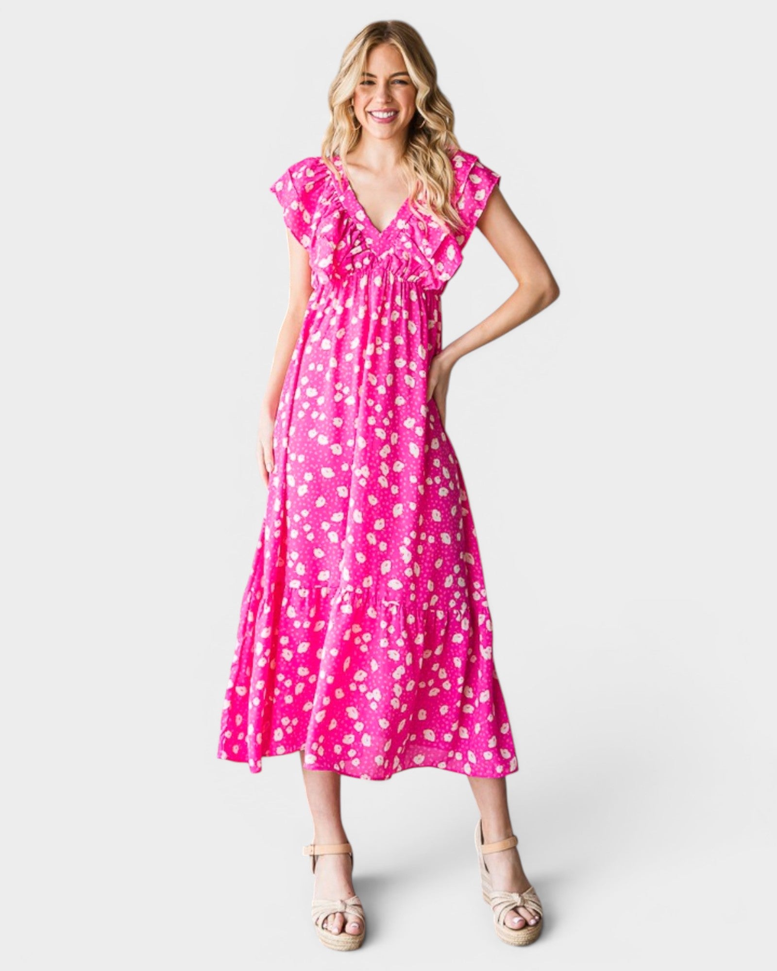 Woman wearing a pink dress with white polka dots on a white background