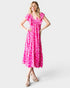 Woman wearing a pink dress with white floral pattern on a white background