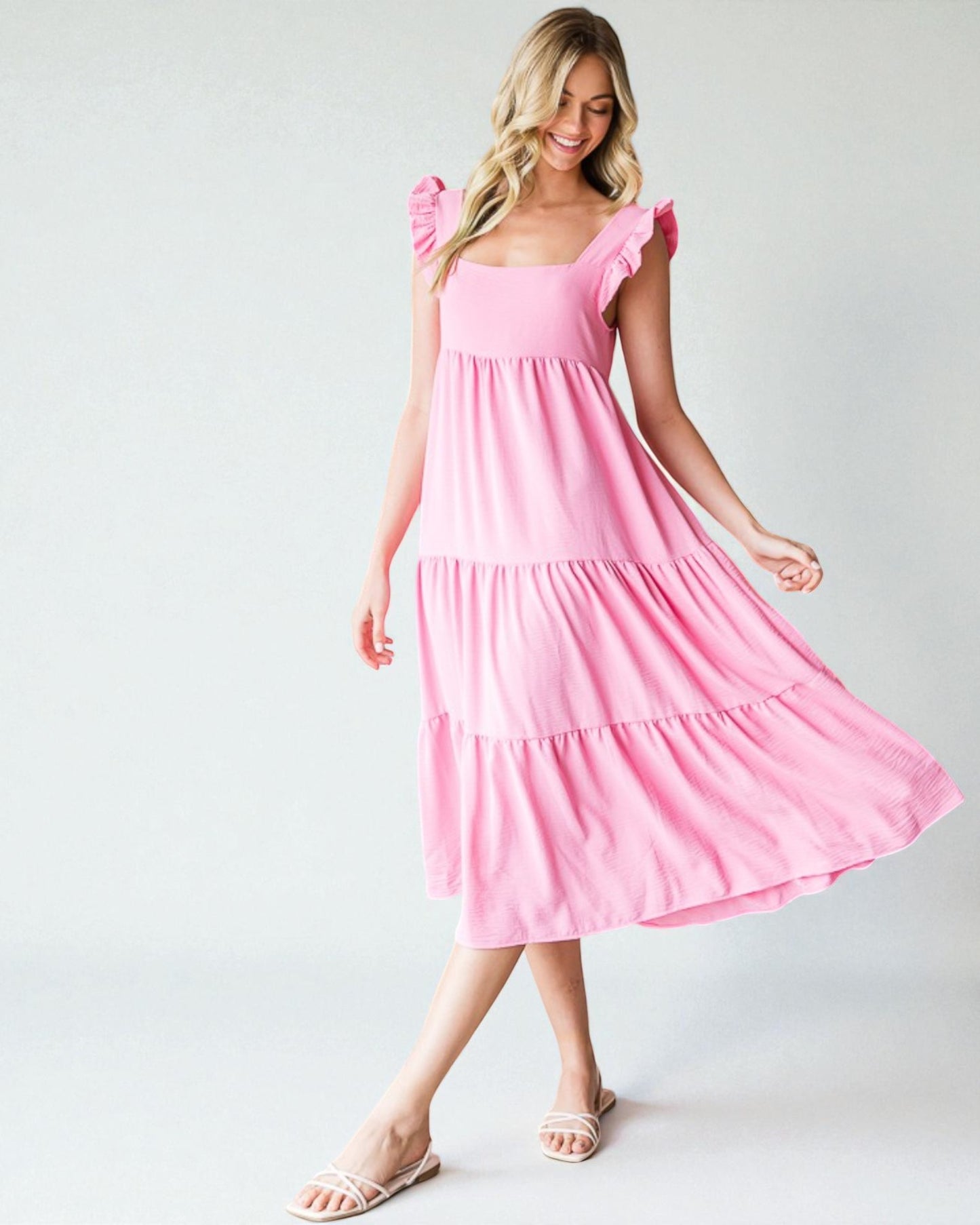 Woman wearing a pink dress on a white background