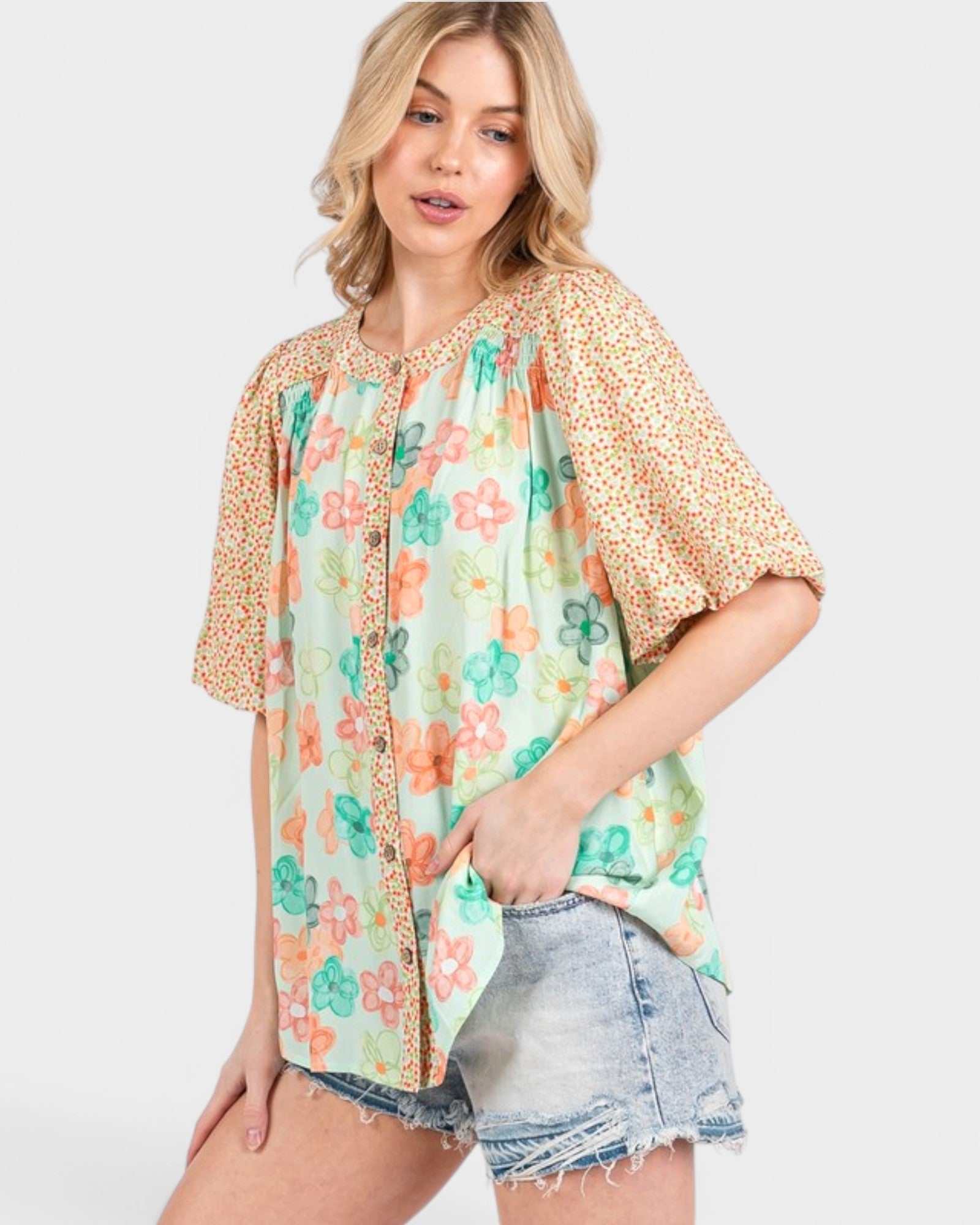 Woman wearing a floral blouse with a plain background