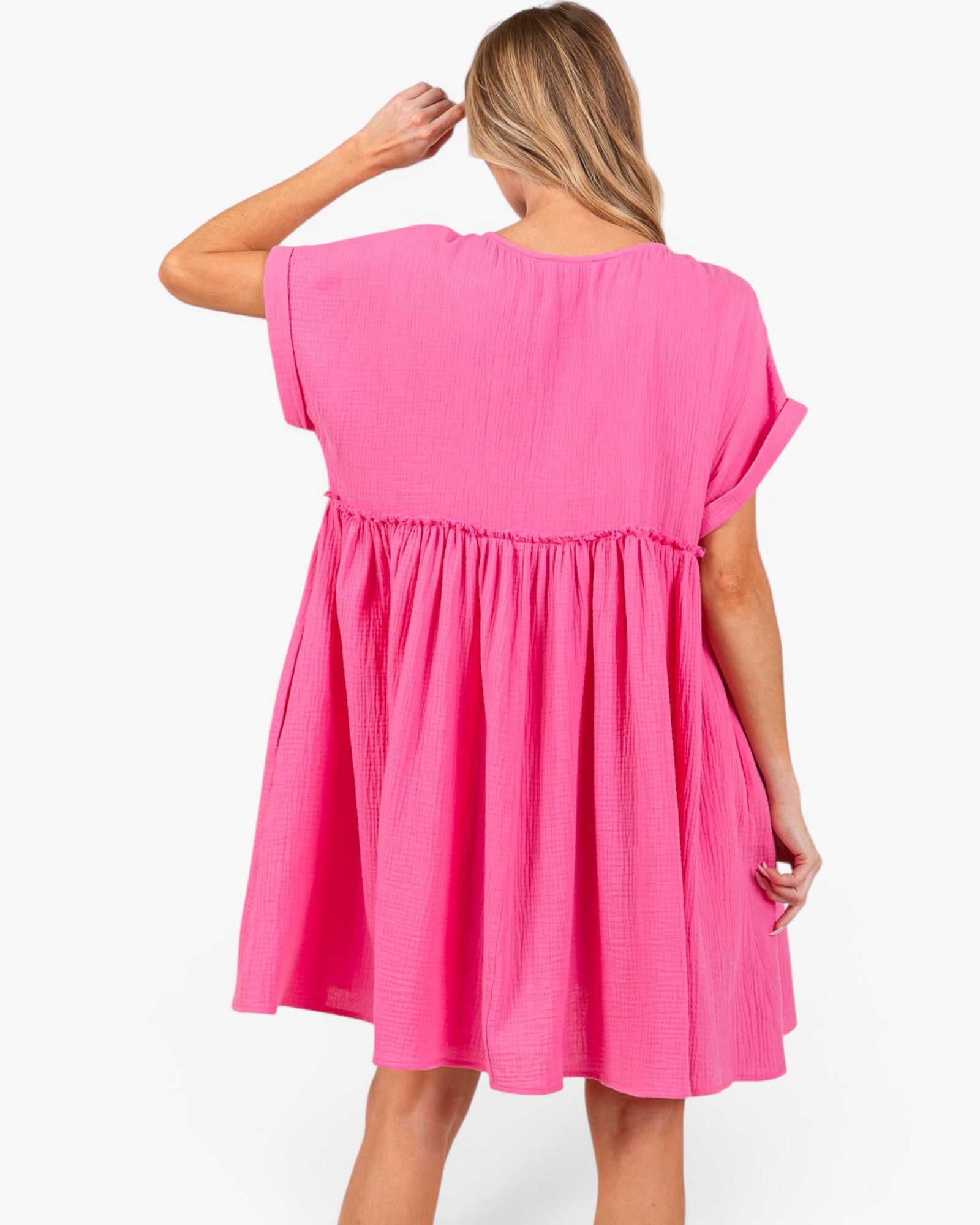 A woman wearing a bright pink short-sleeve dress, shown from the back against a plain white background.