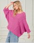 Woman wearing a pink knitted sweater against a white background