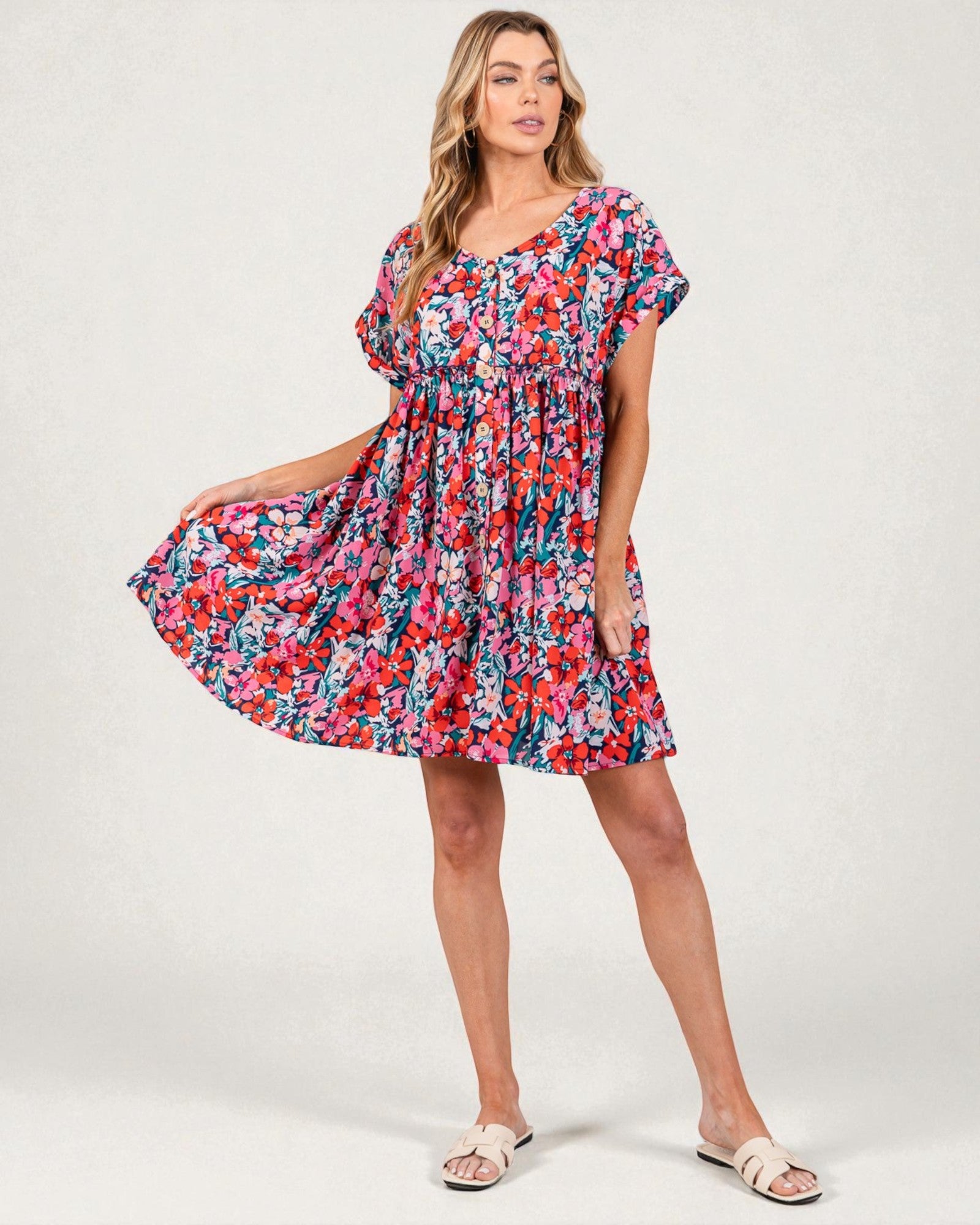 Woman wearing a colorful floral dress on a white background