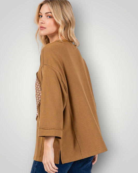 Woman wearing a brown jacket against a plain background