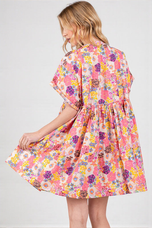 Woman wearing a colorful floral dress on a white background