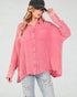 Woman wearing a pink plaid shirt and black cap on a white background