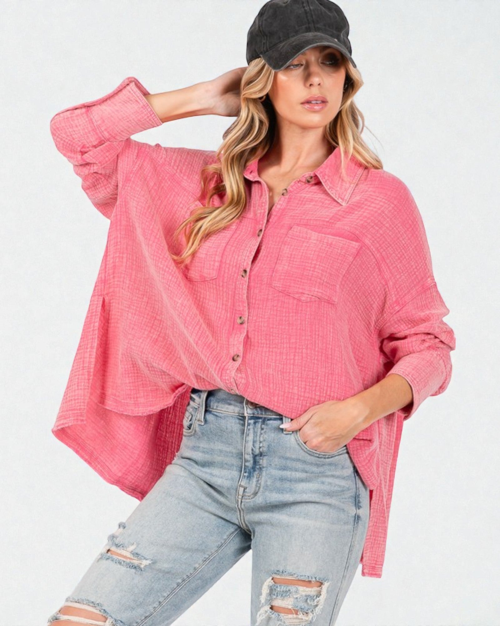 Woman wearing a pink plaid shirt and denim jeans on a white background
