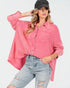Woman wearing a pink plaid shirt and denim jeans on a white background