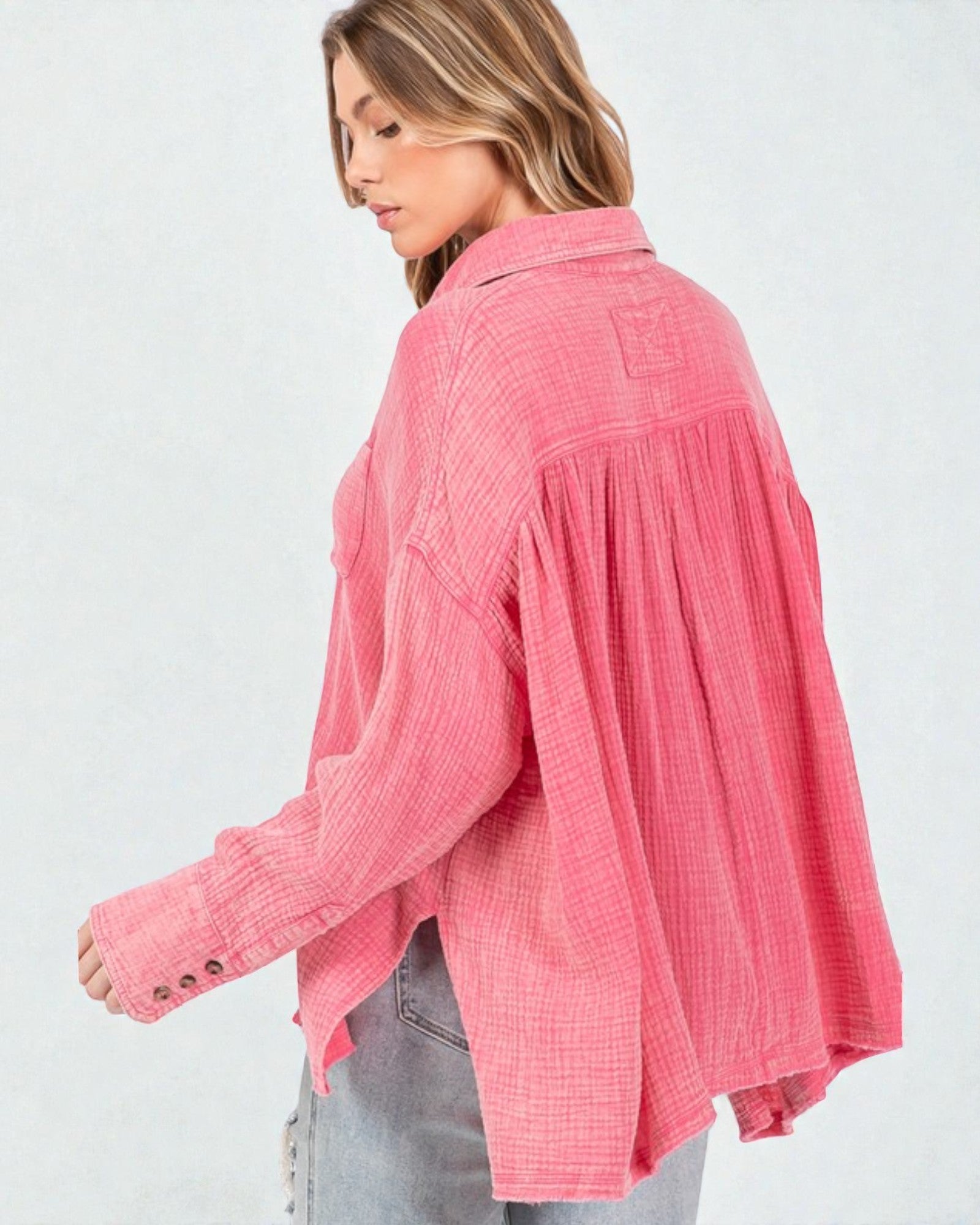 Woman wearing a pink textured shirt on a white background