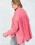 Woman wearing a pink textured shirt on a white background