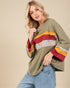 Woman wearing a colorful sweater with a beige background