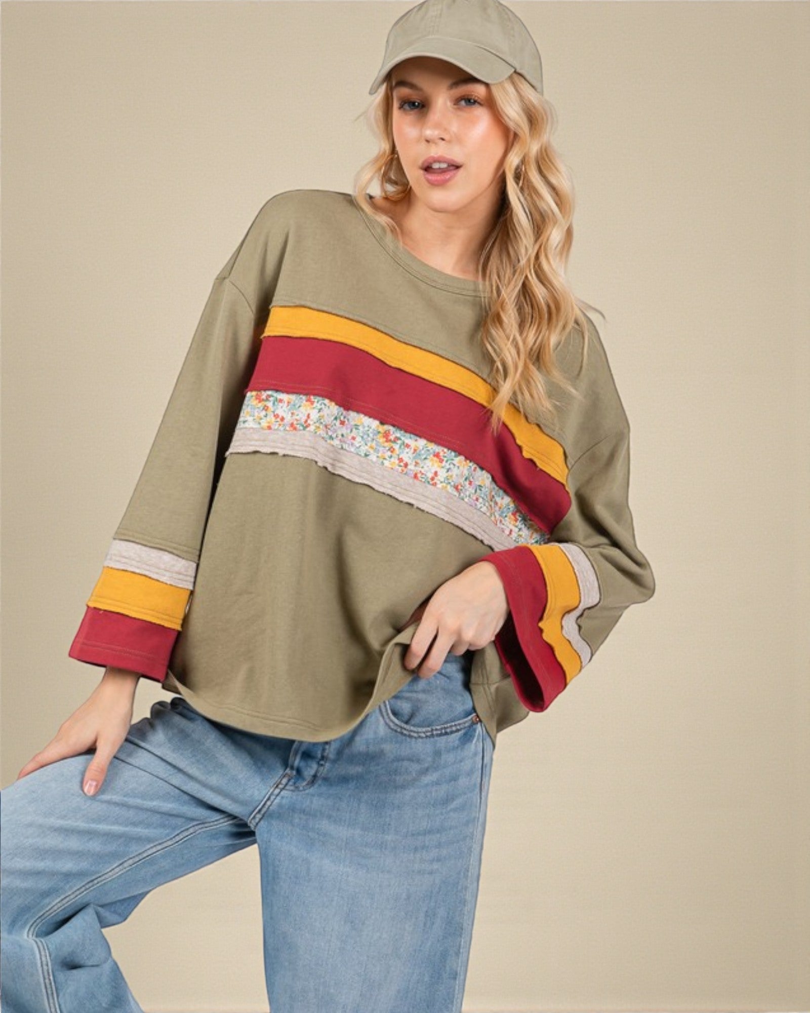 Woman wearing a colorful sweater with a neutral background