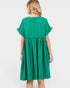 A woman viewed from the back wearing a bright green short-sleeve dress with a gathered waist, against a plain light gray studio background.