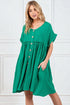 Woman wearing a green dress with a white background