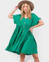 A woman modeling a bright green short-sleeve button-front dress with a gathered waist, paired with a brown wide-brim hat, against a light gray studio background.