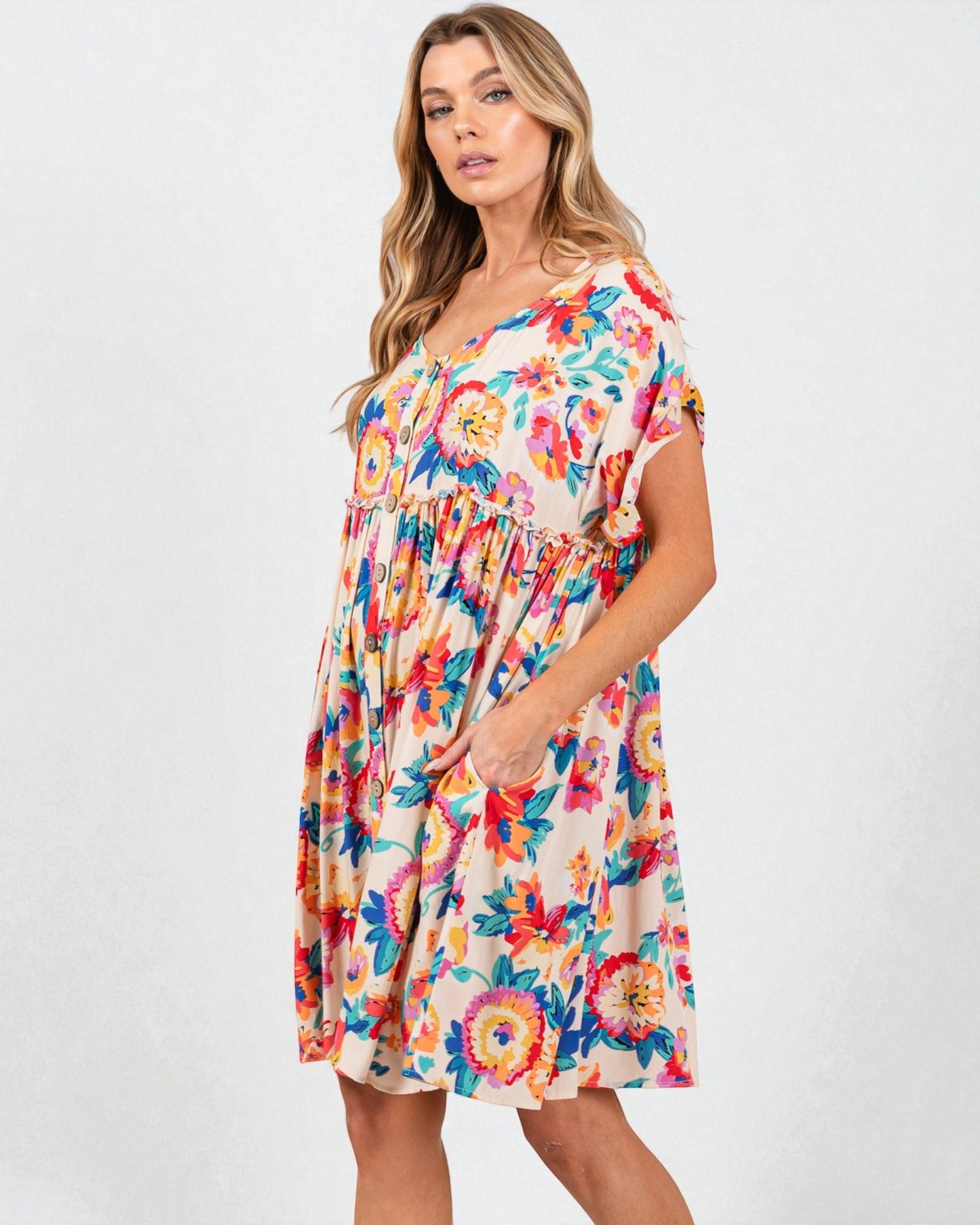 Woman wearing a colorful floral dress on a white background
