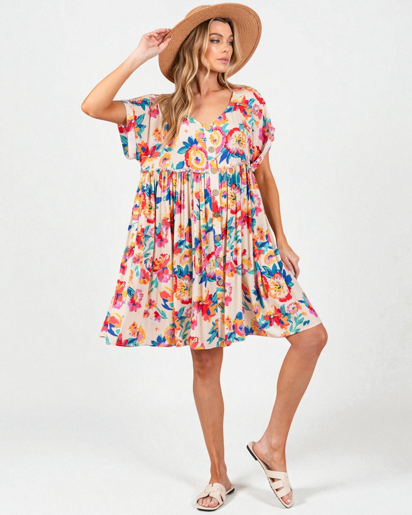 Woman wearing a colorful floral dress on a white background