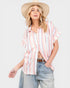 Woman wearing a striped shirt and wide-brimmed hat on a white background