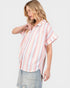 Woman wearing a striped shirt with a plain background