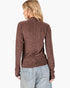 A woman shown from the back wearing a long-sleeve, high-neck knit top in a heathered brown and burgundy color, paired with light-wash blue jeans, against a plain white background.