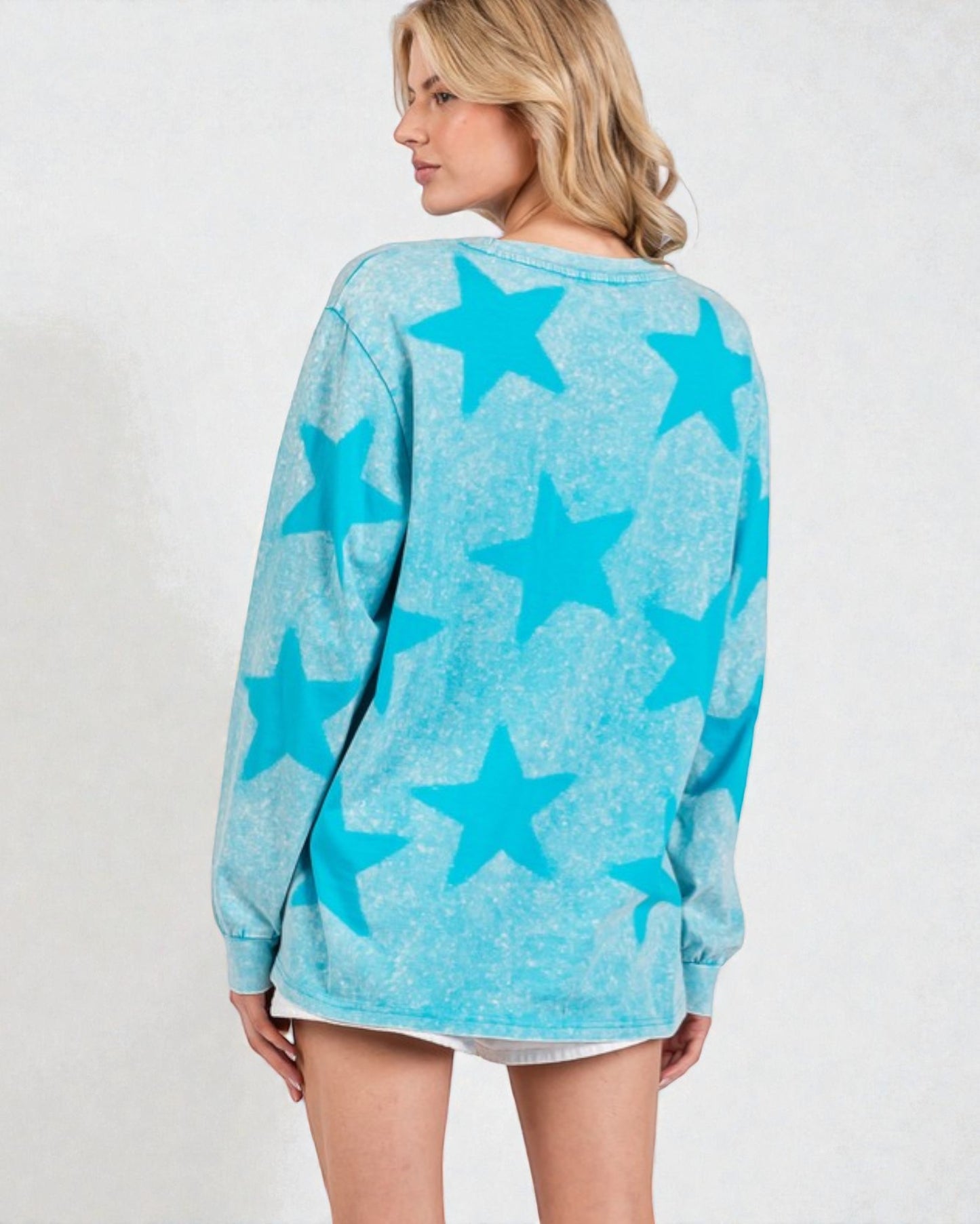 Woman wearing a blue star-patterned sweater on a white background